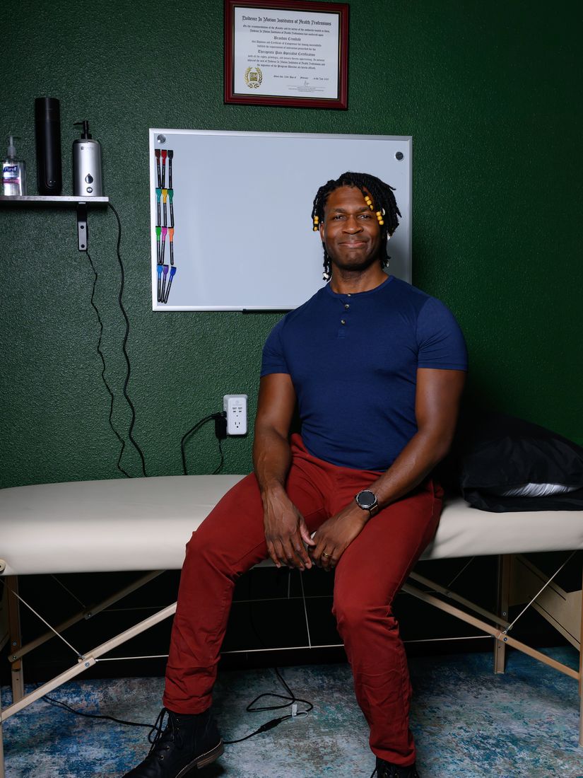 Brandon Crosdale seated on a treatment table in the CrosaCore clinic