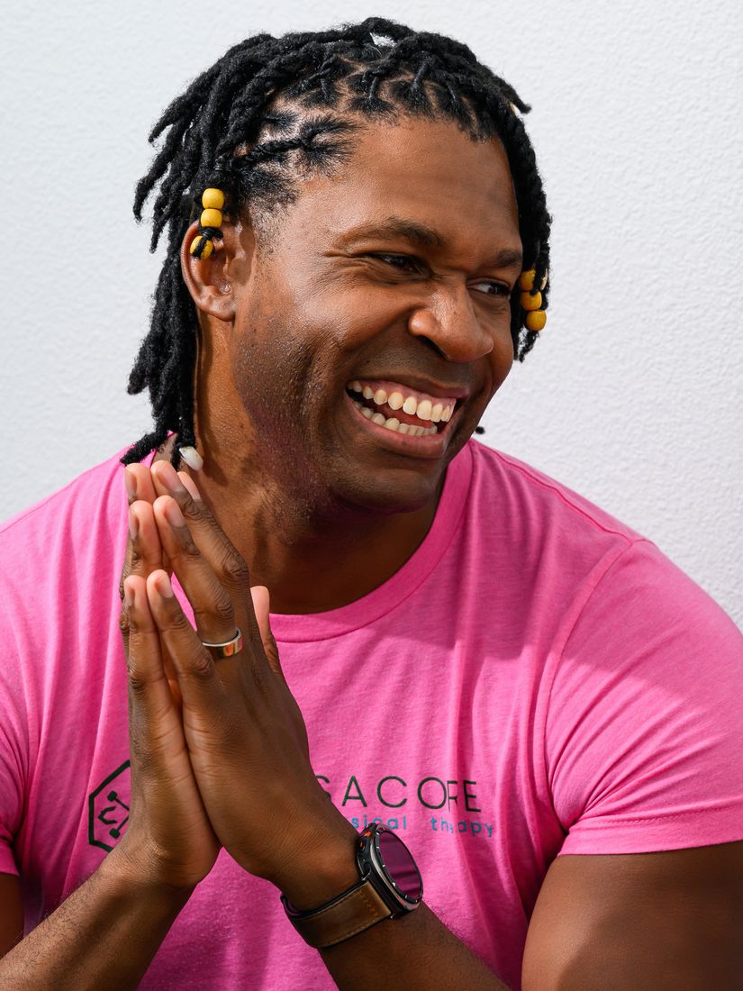 Brandon laughing, hands pressed together, mid-conversation