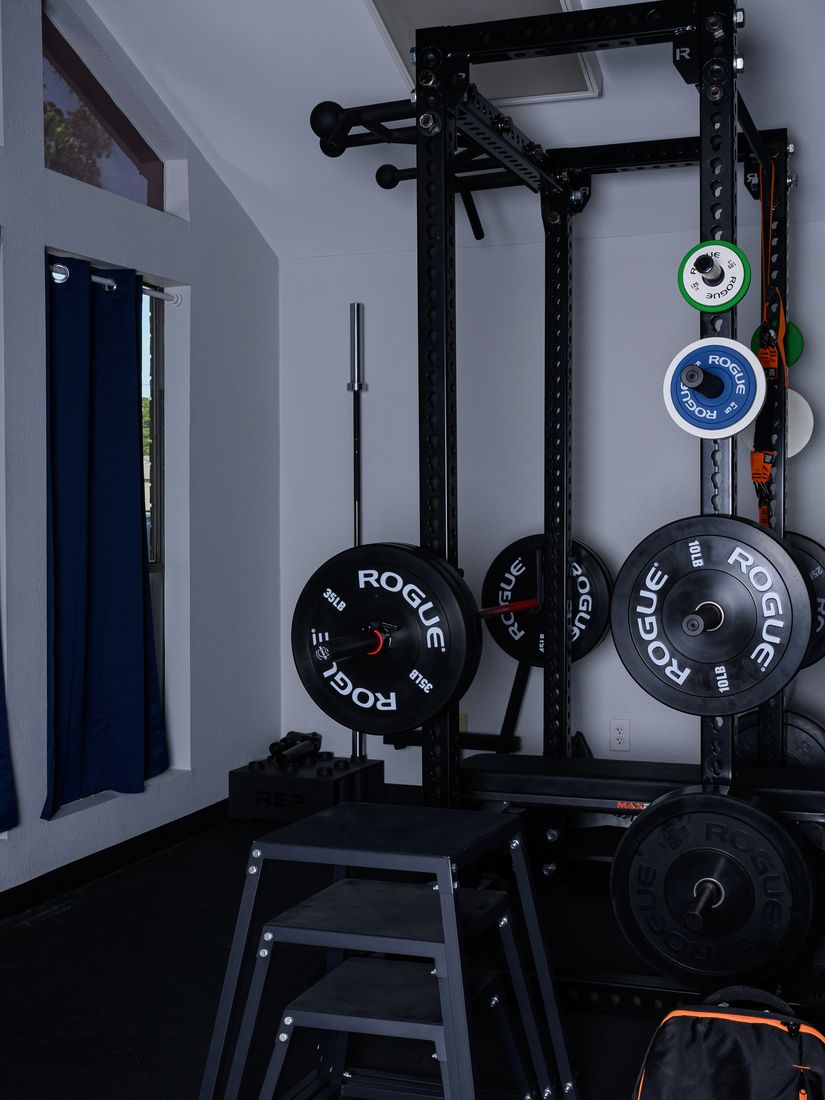 Rogue squat rack, bumper plates, and plyometric boxes in the clinic