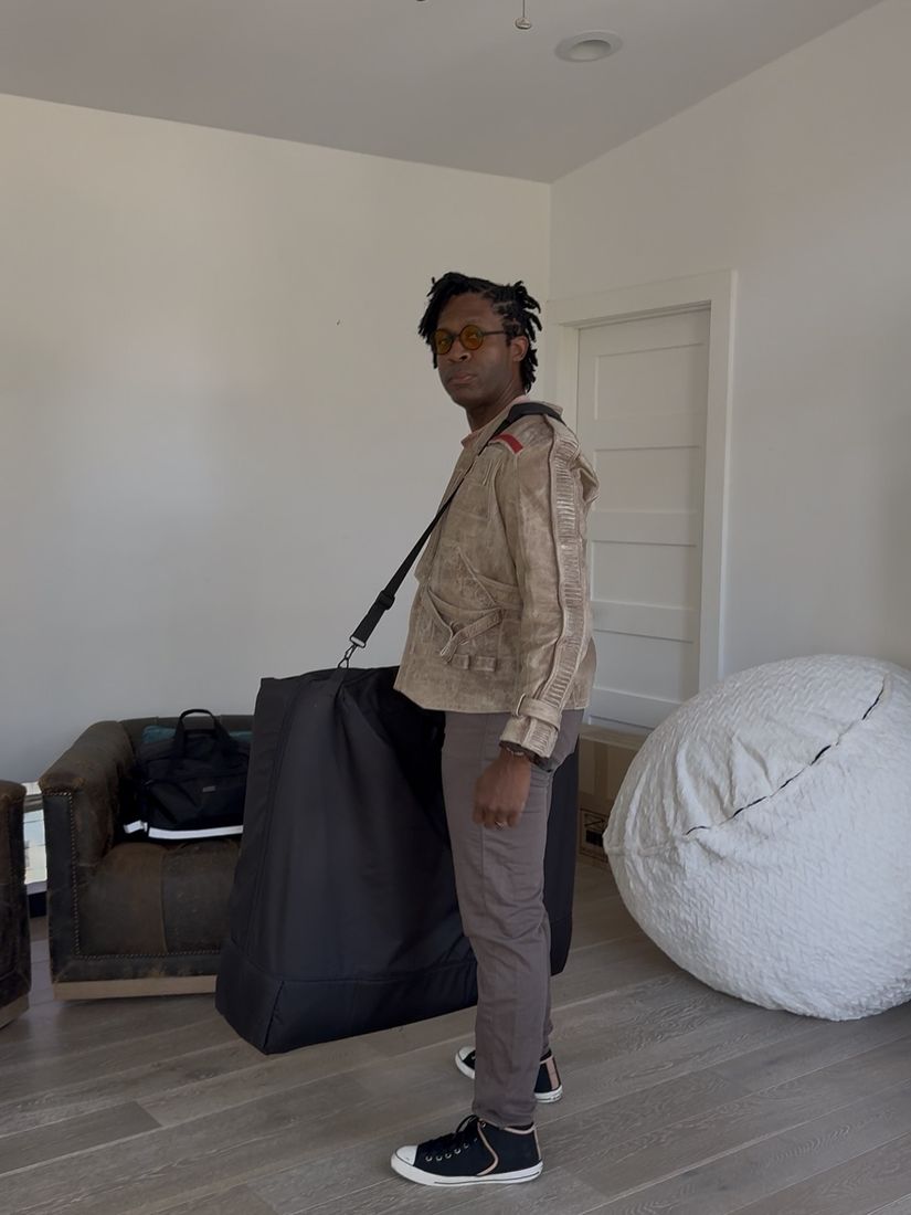 Brandon arriving at a client’s home carrying the portable treatment table