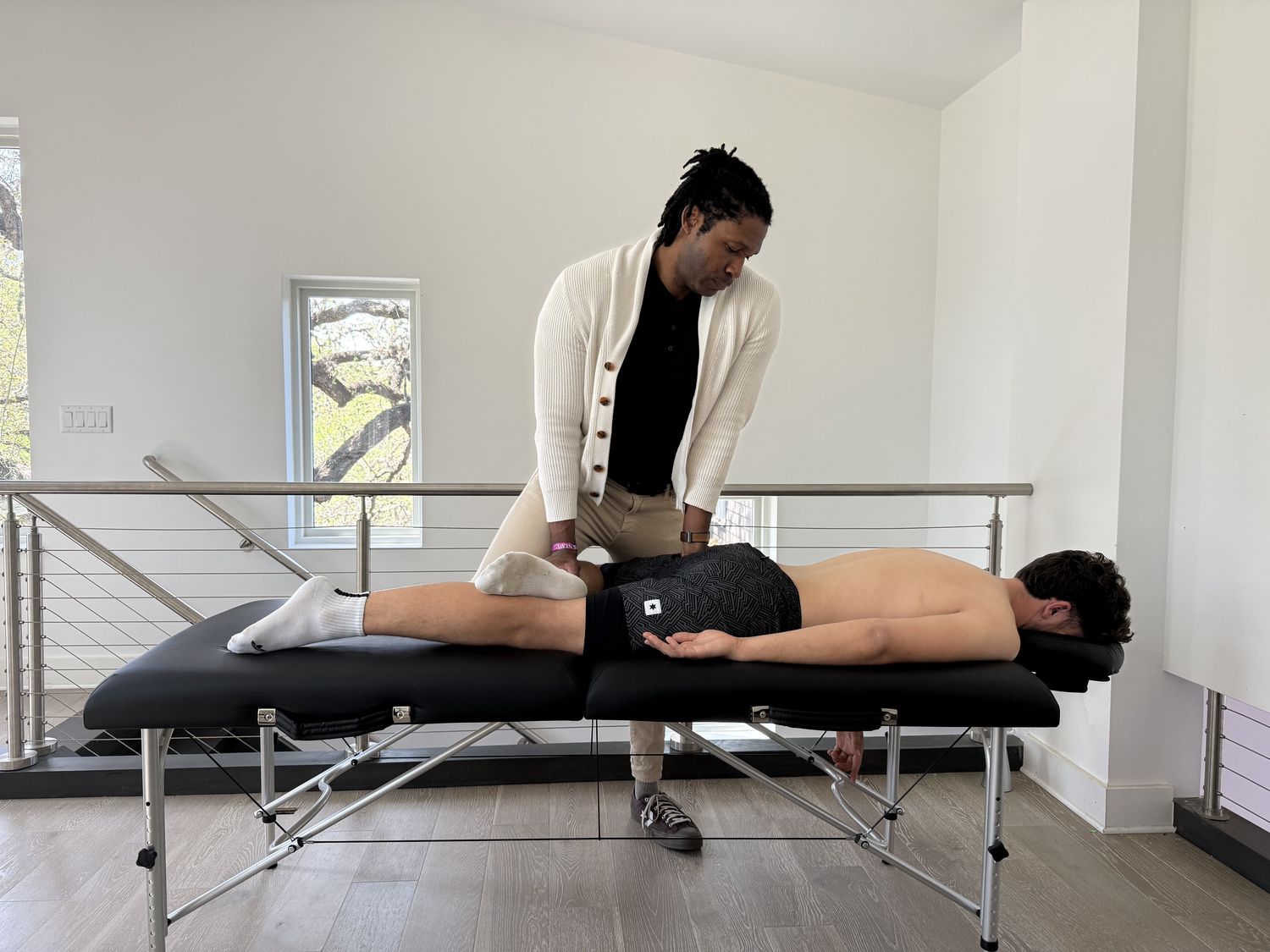 Brandon treating a client on a portable table in the client’s home