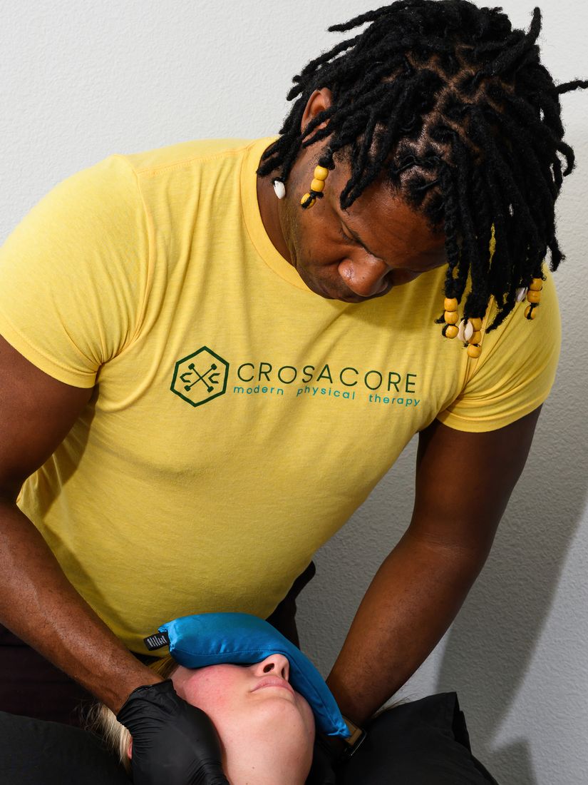 Brandon providing attentive hands-on care at a client’s neck