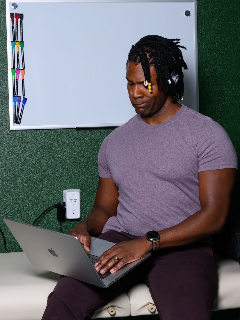 Brandon at a laptop with headphones on during a virtual consultation